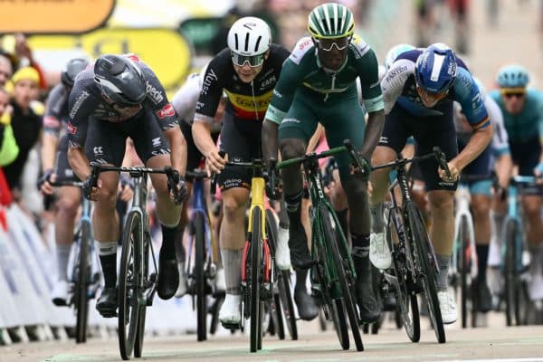 Cyclists sprinting in a tight road race finish