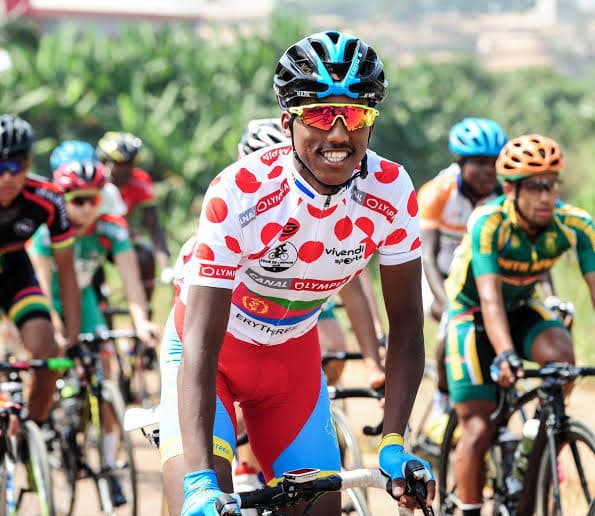 Cyclist wearing professional race kit and helmet